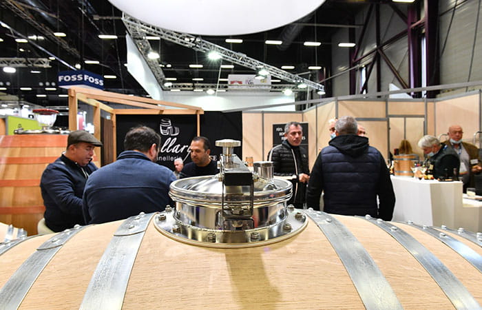 Men in front of a wine barrel