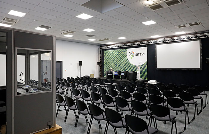 Press area with chairs, podium and translator's box