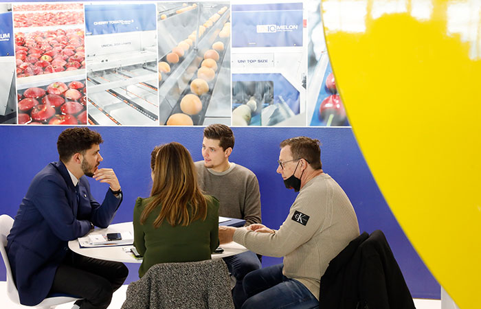 Four people discussing around a table