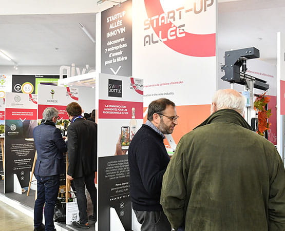 Personnes discutant lors d'un business meeting devant le stand d'une start-up